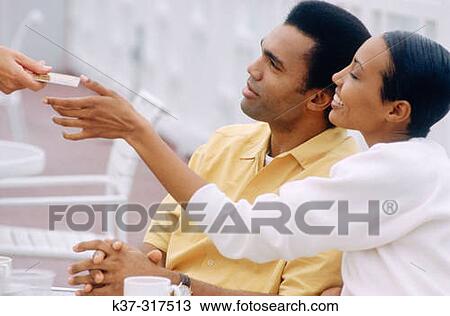 Couple paying for meal with credit card View Large Photo Image Stock Image - Couple paying for meal with credit card. Fotosearch