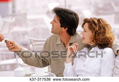Stock Photo - Couple paying for meal with credit card. Fotosearch