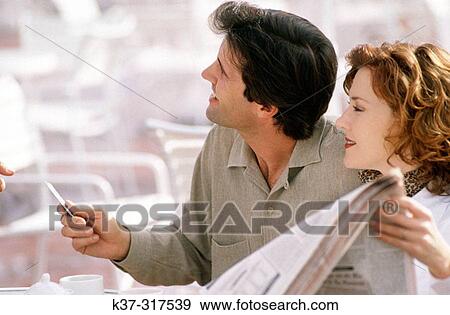 Couple paying for meal with credit card View Large Photo Image Stock Photo - Couple paying for meal with credit card. Fotosearch