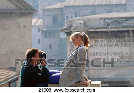 Couple photographing near the Coliseum. Rome. Italy View Large Photo Image Stock Photo - Couple photographing near the Coliseum. Rome. Italy. Fotosearch