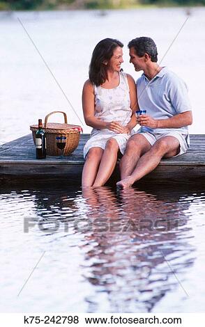 couple picnicking on a dock View Large Photo Image Stock Photo - couple picnicking on a dock. Fotosearch