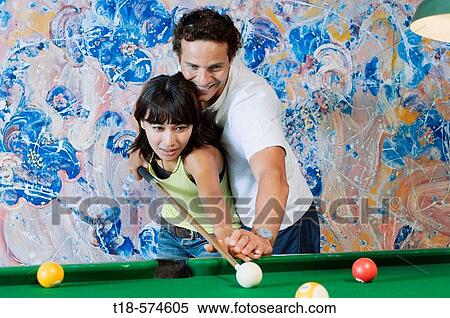 couple playing billiard with painting in the background View Large Photo Image Stock Photography - couple playing billiard with painting in the background. Fotosearch