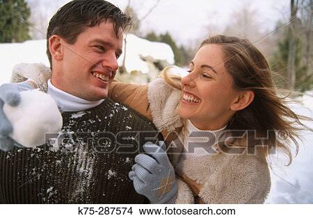 couple playing in the snow View Large Photo Image Picture - couple playing in the snow. Fotosearch