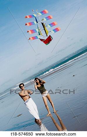 couple playing kite on beach View Large Photo Image Stock Image - couple playing kite on beach. Fotosearch