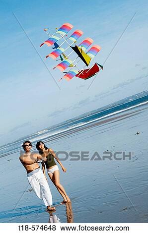 couple playing kite on beach View Large Photo Image Stock Photo - couple playing kite on beach. Fotosearch