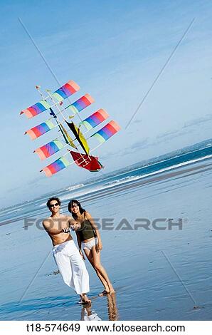 couple playing kite on beach View Large Photo Image Stock Photo - couple playing kite on beach. Fotosearch