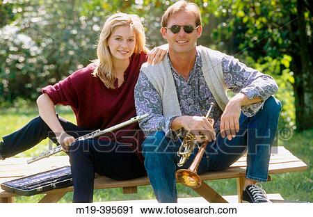 Stock Image - couple playing music outdoors. Fotosearch