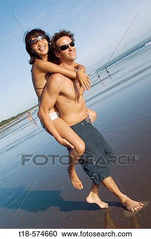 couple playing on beach View Large Photo Image Stock Image - couple playing on beach. Fotosearch