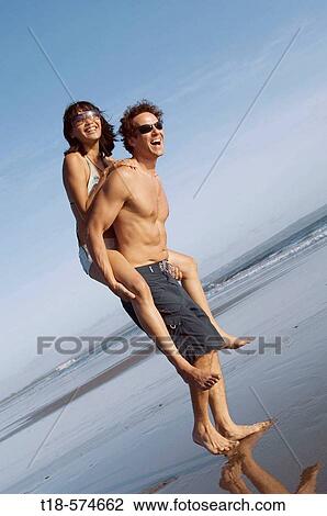 couple playing on beach View Large Photo Image Stock Image - couple playing on beach. Fotosearch
