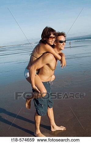 couple playing on beach View Large Photo Image Stock Photo - couple playing on beach. Fotosearch