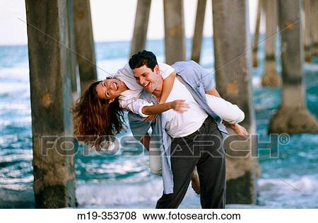 Couple playing under pier View Large Photo Image Stock Photo - Couple playing under pier. Fotosearch