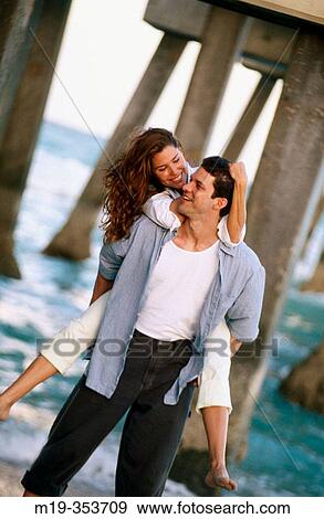 Couple playing under pier View Large Photo Image Stock Photo - Couple playing under pier. Fotosearch