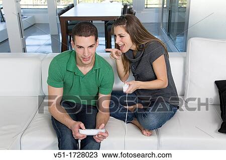 Stock Image - Couple playing videogames at home. Fotosearch