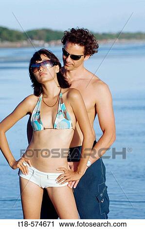 Stock Image - couple posing on beach. Fotosearch