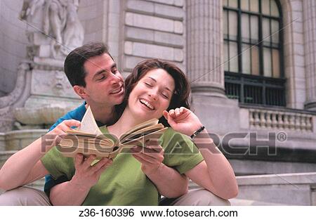 Stock Photograph - Couple reading a book. Fotosearch