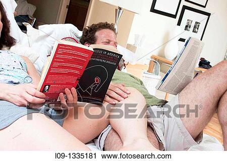 Couple reading in bed View Large Photo Image Stock Image - Couple reading in bed. Fotosearch