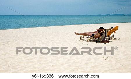 Couple relax in deck chairs on white sand Long Beach Phu Quoc Island Vietnam View Large Photo Image Stock Image - Couple relax in deck chairs on white sand Long Beach Phu Quoc Island Vietnam. Fotosearch