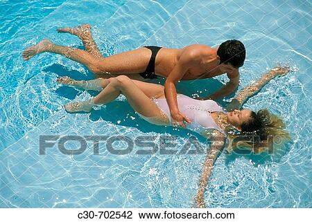 Couple relax in pool View Large Photo Image Stock Image - Couple relax in pool. Fotosearch
