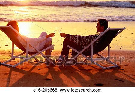 Stock Photo - Couple relaxing at the beach. Fotosearch