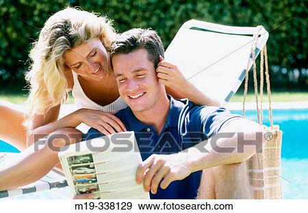 Stock Photo - couple relaxing by the pool. Fotosearch