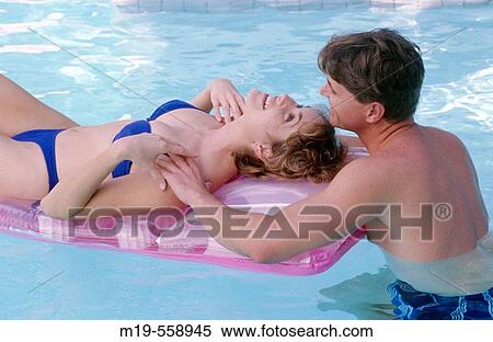 couple relaxing in a pool View Large Photo Image Stock Photography - couple relaxing in a pool. Fotosearch