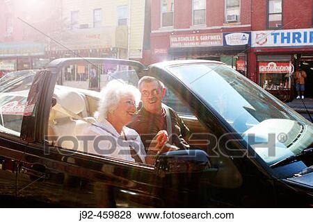 Couple relaxing in convertible car, Greenwich Village, New York City. View Large Photo Image Stock Photo - Couple relaxing in convertible car, Greenwich Village, New York City.. Fotosearch