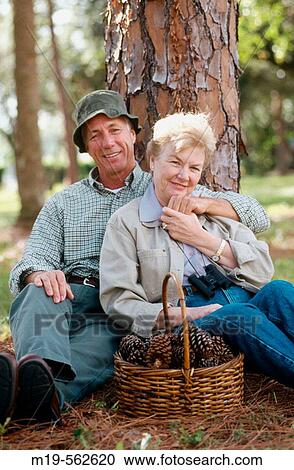 Stock Image - couple relaxing in the woods. Fotosearch