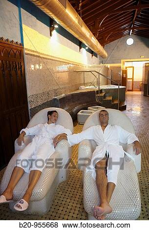 Couple relaxing on hot stone seats, spa-relais. Lierganes hotel and spa, Cantabria, Spain View Large Photo Image Stock Photo - Couple relaxing on hot stone seats, spa-relais. Lierganes hotel and spa, Cantabria, Spain. Fotosearch