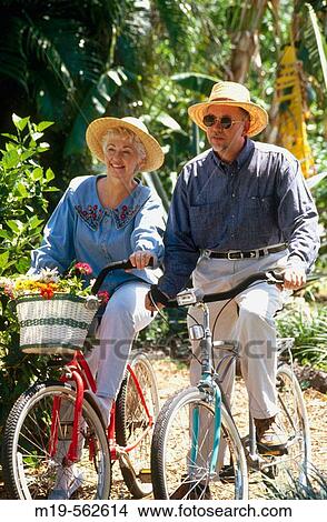 Picture - couple riding a bicycle. Fotosearch