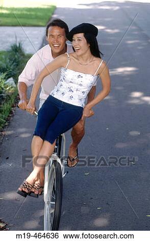 couple riding on a bicycle View Large Photo Image Stock Photograph - couple riding on a bicycle. Fotosearch