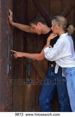Couple ringing doorbell View Large Photo Image Stock Image - Couple ringing doorbell. Fotosearch