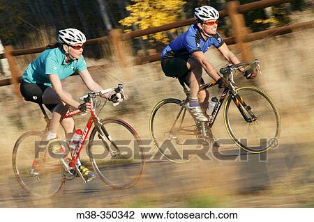 Couple road biking in Sun Valley, Idaho. USA View Large Photo Image Stock Image - Couple road biking in Sun Valley, Idaho. USA. Fotosearch