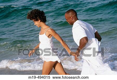 couple running on the beach View Large Photo Image Stock Photography - couple running on the beach. Fotosearch