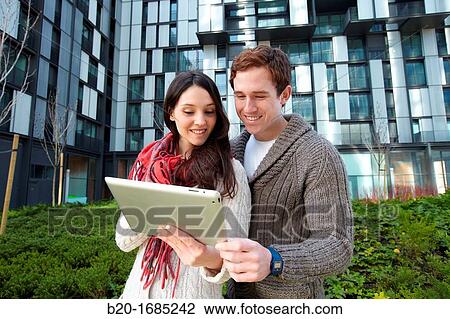 Couple searching on digital tablet in city, digital tablet, Abandoibarra, Bilbao, Bizkaia, Basque Country, Spain View Large Photo Image Stock Image - Couple searching on digital tablet in city, digital tablet, Abandoibarra, Bilbao, Bizkaia, Basque Country, Spain. Fotosearch