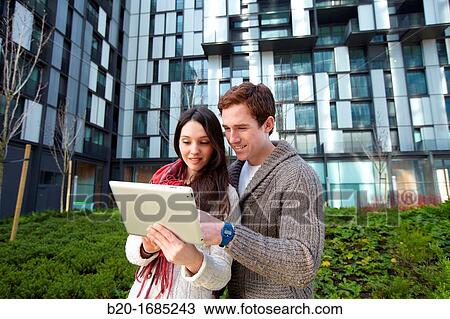Couple searching on digital tablet in city, digital tablet, Abandoibarra, Bilbao, Bizkaia, Basque Country, Spain View Large Photo Image Stock Image - Couple searching on digital tablet in city, digital tablet, Abandoibarra, Bilbao, Bizkaia, Basque Country, Spain. Fotosearch