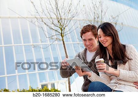 Couple searching on digital tablet in city, digital tablet, Iberdrola Tower, Abandoibarra, Bilbao, Bizkaia, Basque Country, Spain View Large Photo Image Stock Image - Couple searching on digital tablet in city, digital tablet, Iberdrola Tower, Abandoibarra, Bilbao, Bizkaia, Basque Country, Spain. Fotosearch