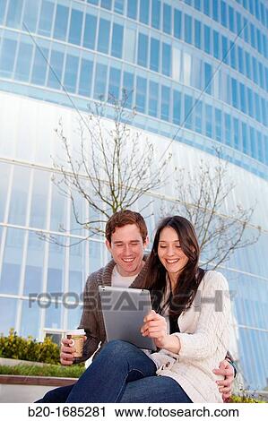 Couple searching on digital tablet in city, digital tablet, Iberdrola Tower, Abandoibarra, Bilbao, Bizkaia, Basque Country, Spain View Large Photo Image Stock Image - Couple searching on digital tablet in city, digital tablet, Iberdrola Tower, Abandoibarra, Bilbao, Bizkaia, Basque Country, Spain. Fotosearch