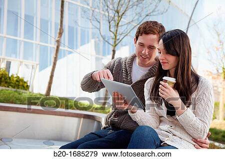 Couple searching on digital tablet in city, digital tablet, Iberdrola Tower, Abandoibarra, Bilbao, Bizkaia, Basque Country, Spain View Large Photo Image Stock Photo - Couple searching on digital tablet in city, digital tablet, Iberdrola Tower, Abandoibarra, Bilbao, Bizkaia, Basque Country, Spain. Fotosearch