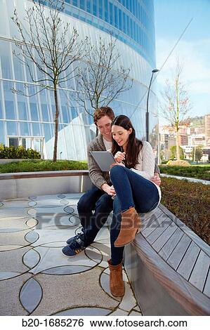 Couple searching on digital tablet in city, digital tablet, Iberdrola Tower, Abandoibarra, Bilbao, Bizkaia, Basque Country, Spain View Large Photo Image Stock Photograph - Couple searching on digital tablet in city, digital tablet, Iberdrola Tower, Abandoibarra, Bilbao, Bizkaia, Basque Country, Spain. Fotosearch