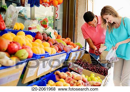 Couple shopping. Buying in Fruit Shop. San Sebastian. Donostia. Gipuzkoa. Basque Country. Spain. View Large Photo Image Stock Photo - Couple shopping. Buying in Fruit Shop. San Sebastian. Donostia. Gipuzkoa. Basque Country. Spain.. Fotosearch