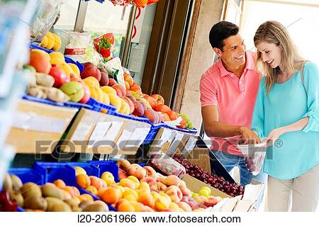 Couple shopping. Buying in Fruit Shop. San Sebastian. Donostia. Gipuzkoa. Basque Country. Spain. View Large Photo Image Stock Photograph - Couple shopping. Buying in Fruit Shop. San Sebastian. Donostia. Gipuzkoa. Basque Country. Spain.. Fotosearch