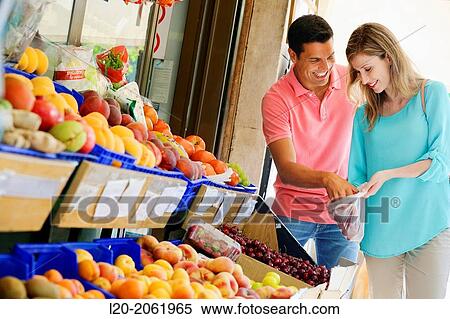 Couple shopping. Buying in Fruit Shop. San Sebastian. Donostia. Gipuzkoa. Basque Country. Spain. View Large Photo Image Stock Photography - Couple shopping. Buying in Fruit Shop. San Sebastian. Donostia. Gipuzkoa. Basque Country. Spain.. Fotosearch