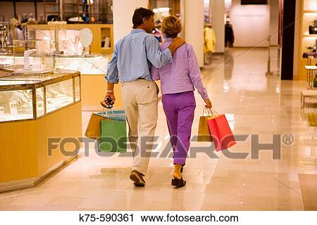 Couple shopping in department store View Large Photo Image Stock Image - Couple shopping in department store. Fotosearch