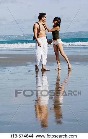 couple sightseeeing on beach View Large Photo Image Picture - couple sightseeeing on beach. Fotosearch