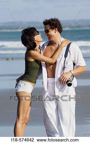 couple sightseeing and embracing on beach View Large Photo Image Stock Image - couple sightseeing and embracing on beach. Fotosearch