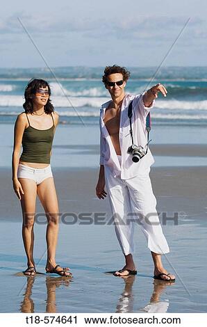 couple sightseeing on beach View Large Photo Image Stock Image - couple sightseeing on beach. Fotosearch