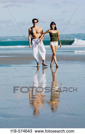 couple sightseeing on beach View Large Photo Image Stock Image - couple sightseeing on beach. Fotosearch