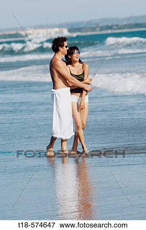 Stock Photo - couple sightseeing on beach. Fotosearch