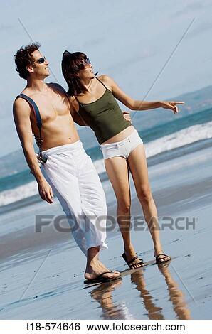couple sightseeing on beach View Large Photo Image Stock Photograph - couple sightseeing on beach. Fotosearch