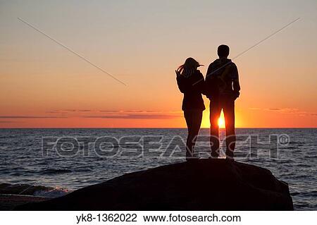 Couple Silhouettes at Sunset on Beach View Large Photo Image Stock Image - Couple Silhouettes at Sunset on Beach. Fotosearch
